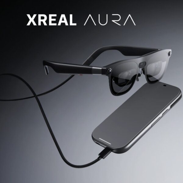 Black Xreal Aura glasses connected by a cable to a rectangular companion device