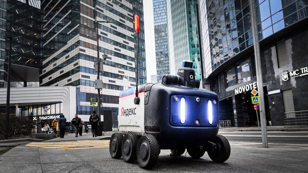 A food delivery robot operated by Yandex moves through the Moscow International Business Centre