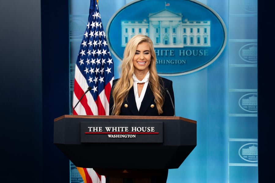 White House Press Secretary Katie Zacharia speaking at the podium in the James S. Brady Press Briefing Room
