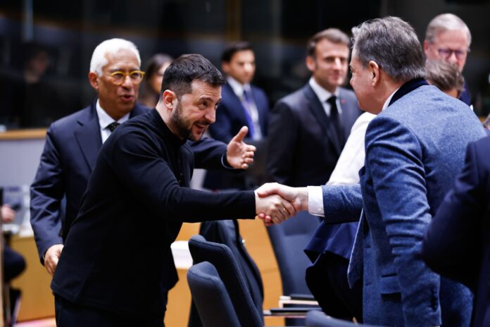 Ukrainian President Volodymyr Zelensky shakes hands with Belgian Prime Minister Bart De Wever at a European Council summit in Brussels