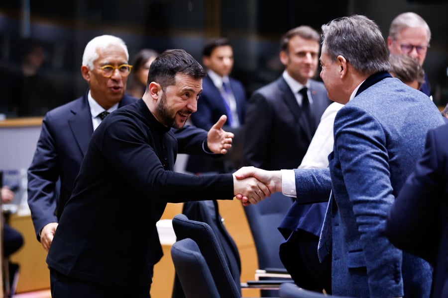 Ukrainian President Volodymyr Zelensky shakes hands with Belgian Prime Minister Bart De Wever at a European Council summit in Brussels