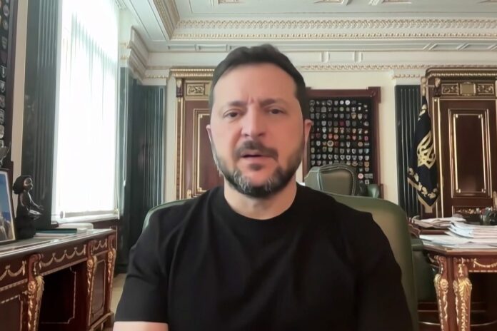 Ukrainian President Volodymyr Zelenskyy in a black shirt speaking from his office in Kyiv